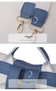 Detail of detachable gold hook and reinforced stitching on contrast leather backpack straps