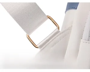 Detail of white textured leather backpack with gold metal buckle and blue stitching