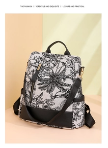 Detail of floral nylon backpack with leather accents under soft sunlight projection