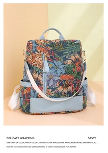 Close-up of floral tapestry backpack fabric with premium blue faux leather accents