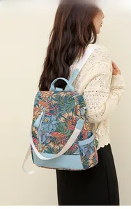 Detailed view of women's vintage floral jacquard backpack with light blue leather accents