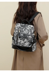 Detailed view of vintage black and white floral pattern on a stylish nylon backpack