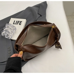 Top view of large dark brown saddle bag with smooth zipper and spacious interior