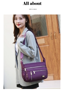 Detail of dark purple waterproof nylon shoulder bag with multiple zippered pockets
