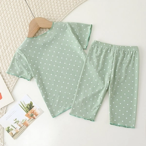 Detail of mint green polka dot toddler pajamas with delicate lettuce edge ribbing trim