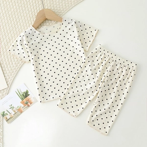 Detail of ribbed toddler pajama set with black polka dots and elastic waistband