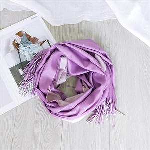 Close-up of elegant lavender purple scarf with soft fringes on a white wooden background