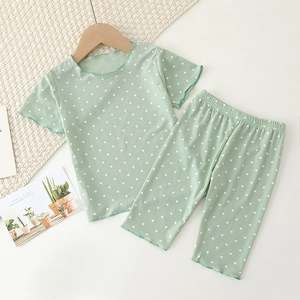 Detail of light green polka dot summer pajamas with soft ribbed fabric and ruffled edges