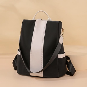Minimalist black and white contrast backpack with large capacity and gold hardware details
