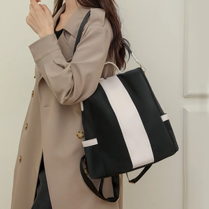 Minimalist black and white color-block backpack for women with soft leather texture