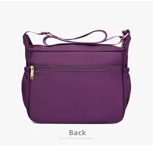 Back view of dark purple oxford fabric shoulder bag with hidden zipper and gold metal hardware