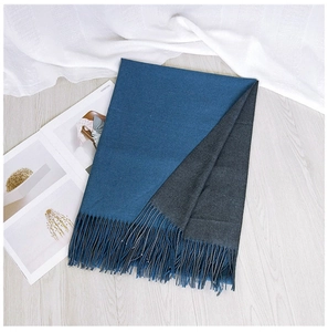 Close-up of two-tone scarf with fringe edges in navy blue and charcoal grey tones
