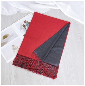 Close-up of red and dark grey double-sided scarf with elegant fringe detail