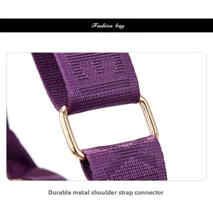 Detail of durable gold metal ring and purple nylon shoulder strap stitching on bag