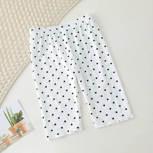 Detail view of vertical ribbed knit texture on white polka dot baby shorts