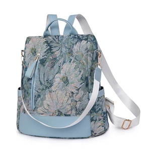 Minimalist nylon floral jacquard backpack with leather trim and wide straps, 45-degree view