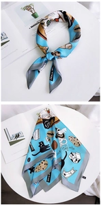 Detail of bright blue silk scarf featuring cute cat and afternoon tea illustration patterns