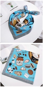 Close-up of light blue silk scarf with cute cat and food illustrations for women