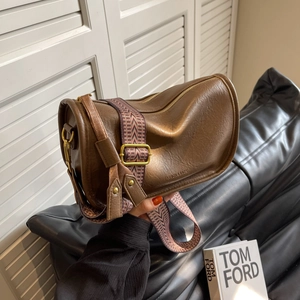 Brown vintage leather cylinder saddle bag with geometric ethnic patterned wide strap