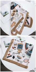 Detail of square silk scarf with cat and dessert prints on cream background