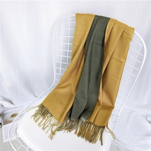 Two-tone long winter scarf in mustard yellow and olive green with tassel edges