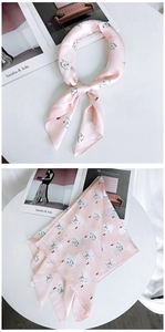 Détail du foulard carré en soie à motif cygne rose avec une texture lisse et chic
