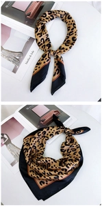 Detail of silk leopard print scarf with black borders and premium satin texture