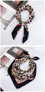 Detail of leopard print silk scarf in beige and red, shown knotted and folded flat