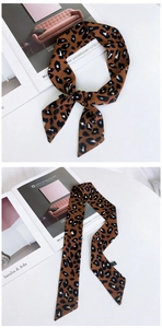 Détail du foulard twilly en soie avec motif léopard montrant le nœud et la texture