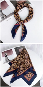 Detail of leopard print silk scarf with camel tones and navy blue border accents
