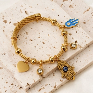 18K gold plated stainless steel twisted bangle with Hamsa Hand and Evil Eye charms
