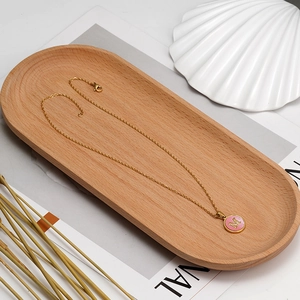 Detailed view of 18K gold stainless steel chain with pink shell M letter pendant