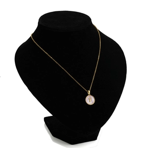 Detail of 18K gold stainless steel necklace with letter F on pink shell pendant