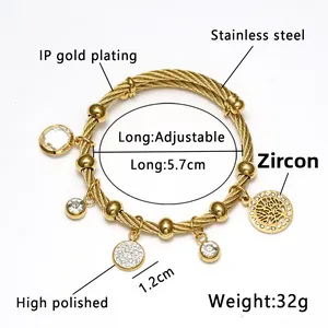 Detail of 18K gold plated stainless steel cable bracelet with Tree of Life and zircon charms