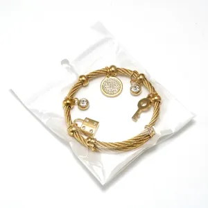 Adjustable 18K gold plated steel cable bracelet with pavé charms and padlock key