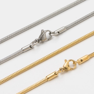 Polished stainless steel snake chain necklace in silver and gold with lobster clasp