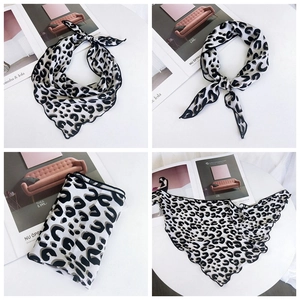 Detail of leopard print silk scarf showing hemmed edges and versatile styling options
