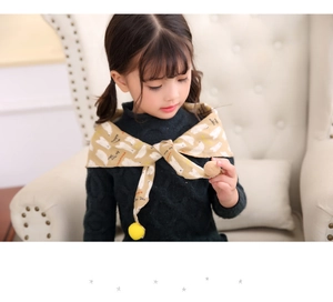 Detail of child's khaki triangle scarf with polar bear prints and yellow pom-pom