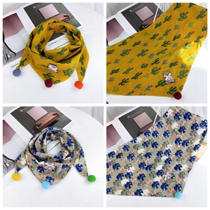 Detailed view of cotton scarves with tassels and cute animal patches for children