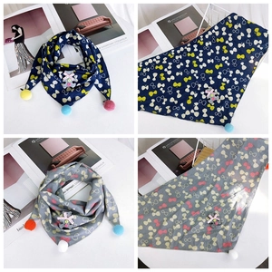 Detailed view of kids cotton triangle scarf with pom-poms and cute bear ornament