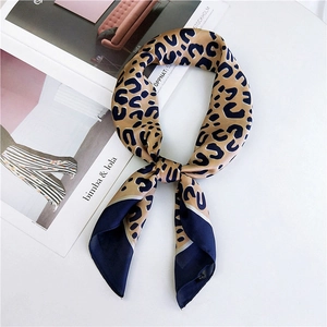Elegant leopard print square silk scarf with navy blue borders and soft drape finish