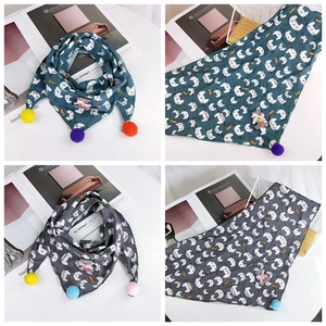 Detail of kids cotton triangle scarves with cartoon rabbit prints and colorful pom-poms