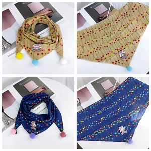 Detail of kids cotton triangle scarf with pom-pom tassels and cute bear patch