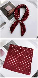 Burgundy polka dot silk scarf shown tied as a necktie and fully unfolded on a white stand