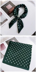Detailed view of dark green polka dot silk scarf with elegant bow knot styling