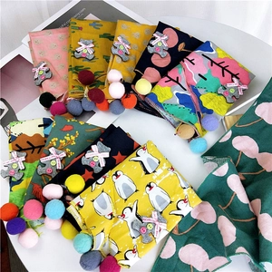 Assorted children's cotton triangle scarves with animal prints and colorful pom-pom trims