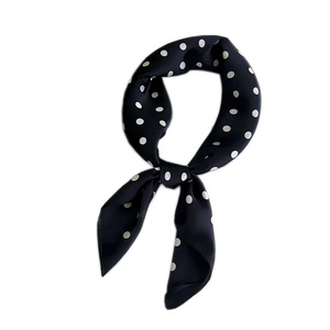 Polka dot silk-like neck scarf for women featuring black base and white pattern