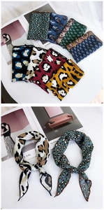 Close-up of leopard print and geometric pattern silk scarves with luxury magazine props