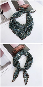 Detail view of teal leopard print neck scarf with professional edge stitching