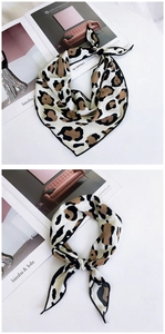 Detail of leopard print silk scarf showing fabric texture and stylish knotting style